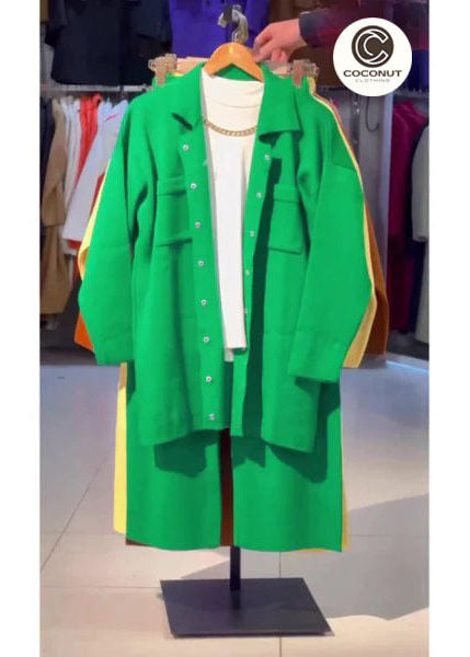Green coat on a mannequin with a blurred store background